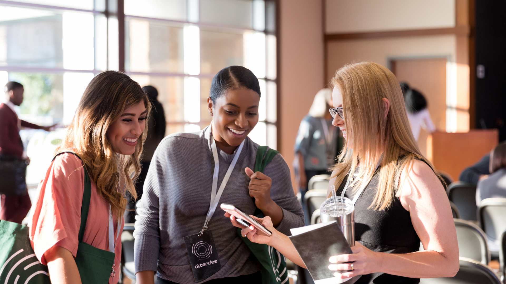 An image of three women at a conference having a conversation